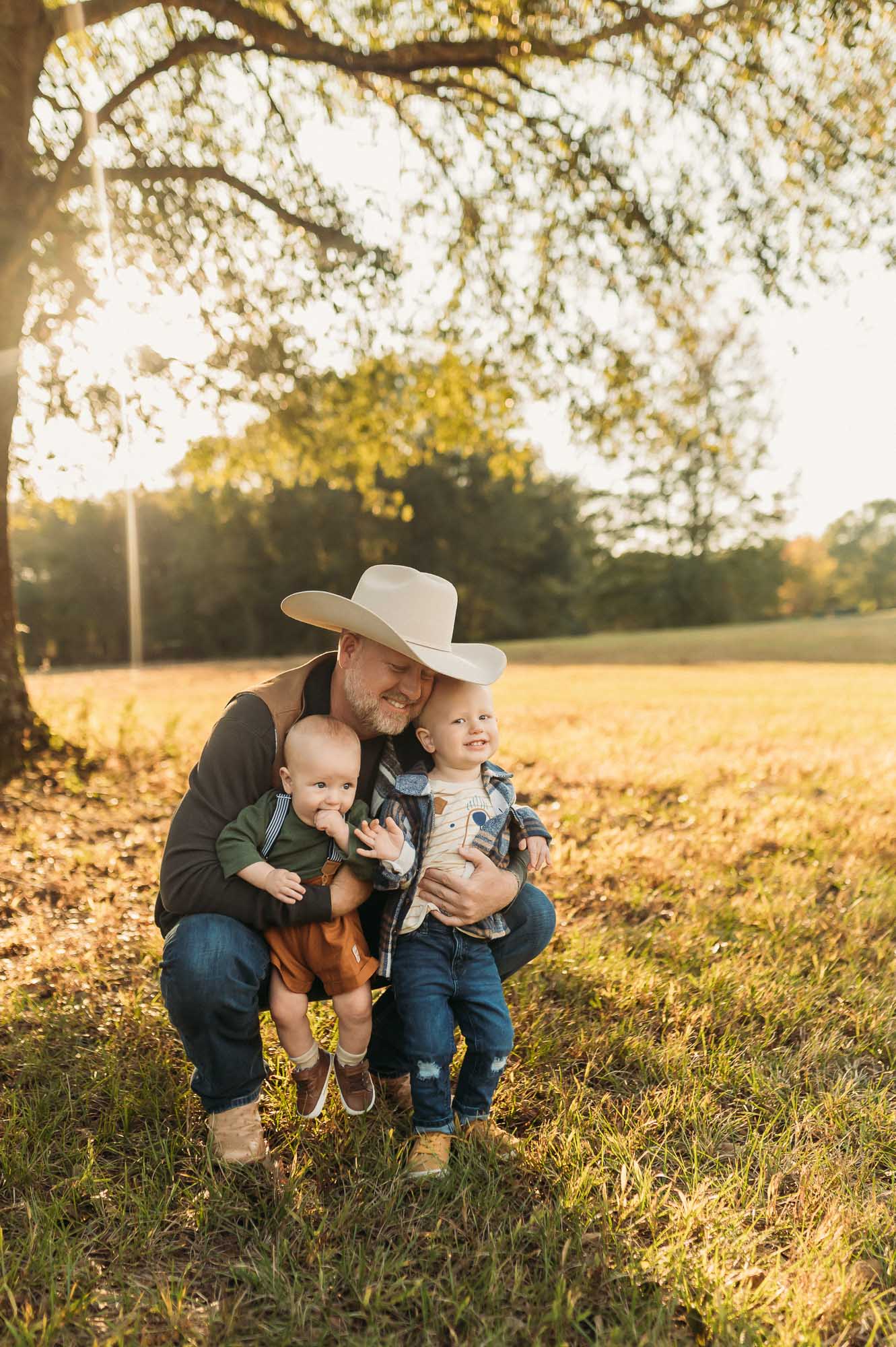 father hugging sons at Mineola Nature Preserve | Mineola TX Family Photographer