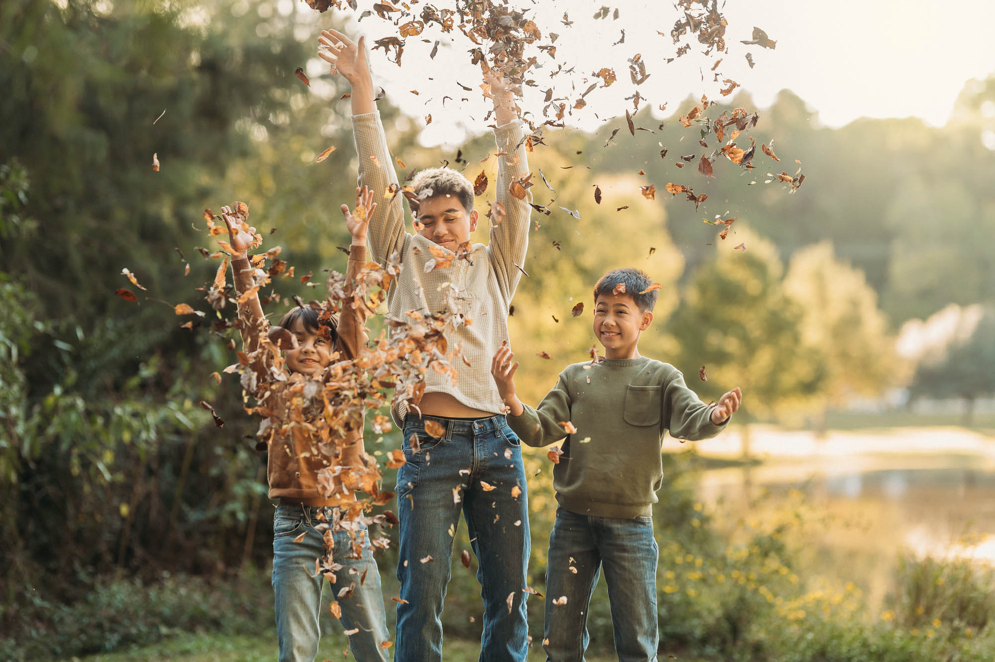 brothers playing in the fall leaves | Family Session in Tyler TX