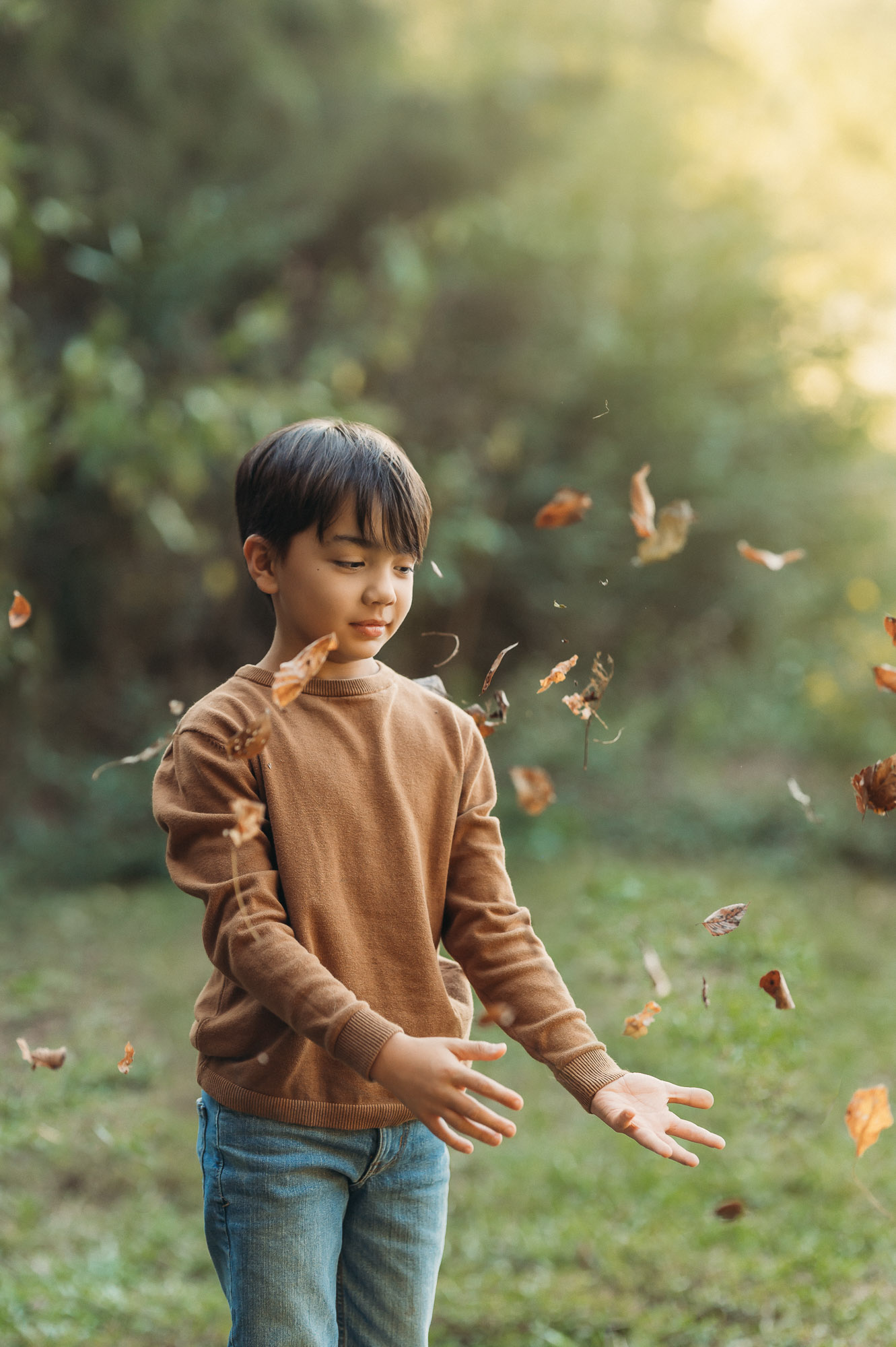 Boy playing in fall leaves | Family Session in Tyler TX