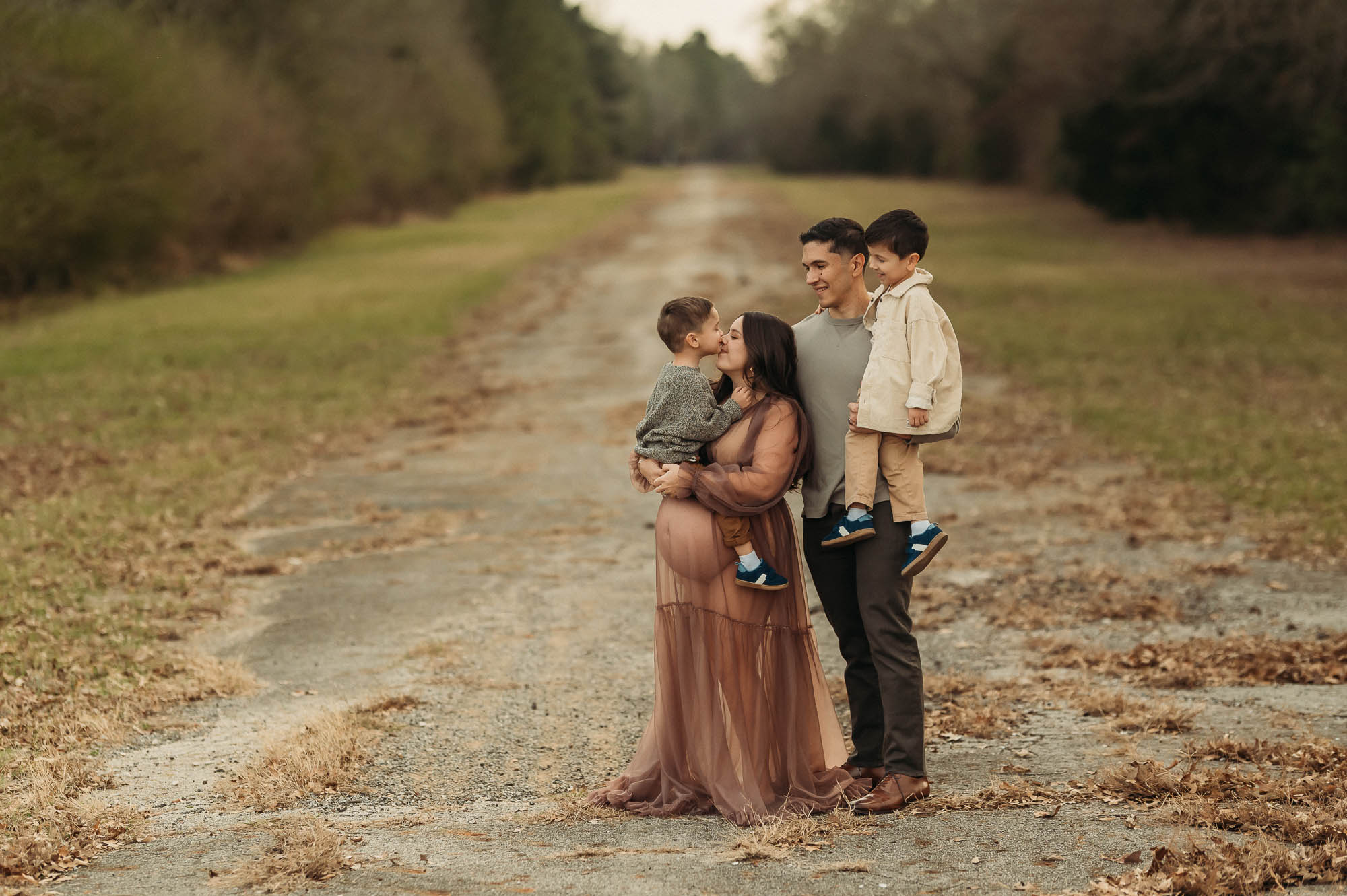 family on fall road | Tyler Texas Maternity Photographer