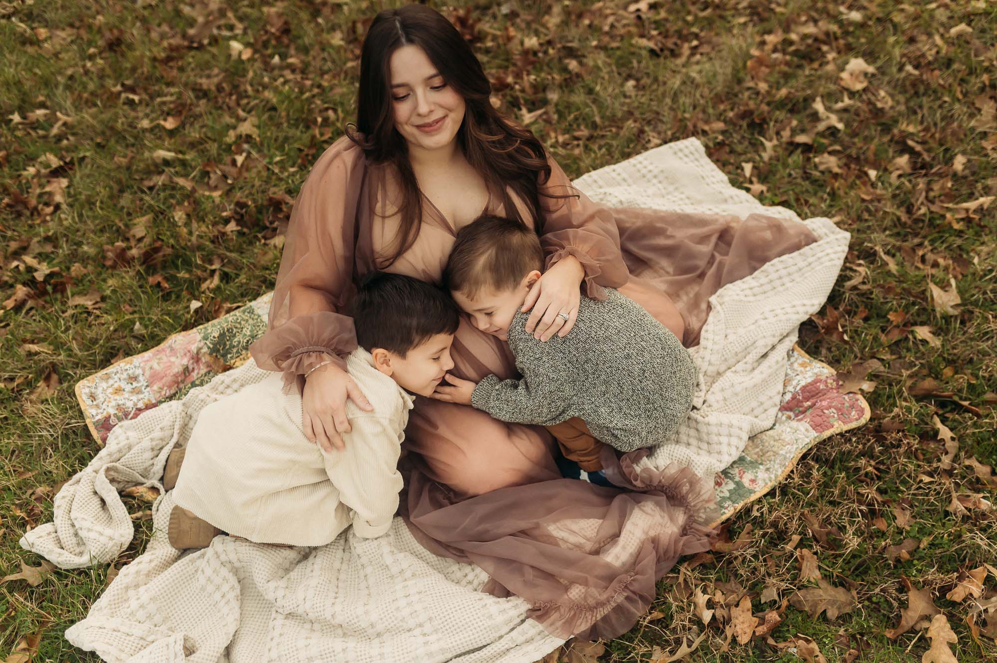 Expecting Mother snuggling with young sons | Tyler Texas Maternity Photographer