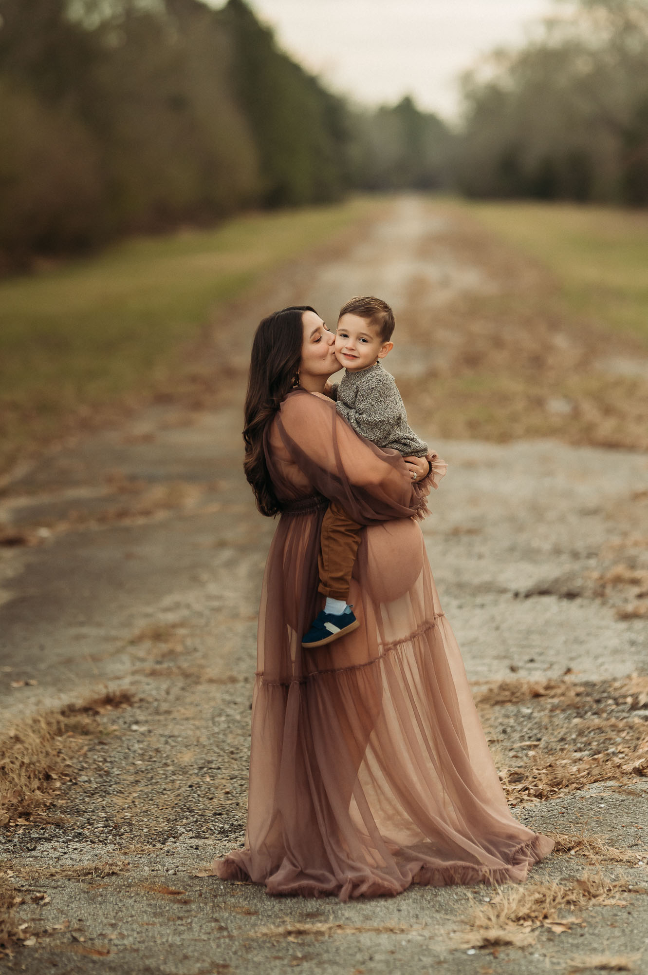 Expecting mom giving kisses to young son | Tyler Texas Maternity Photographer