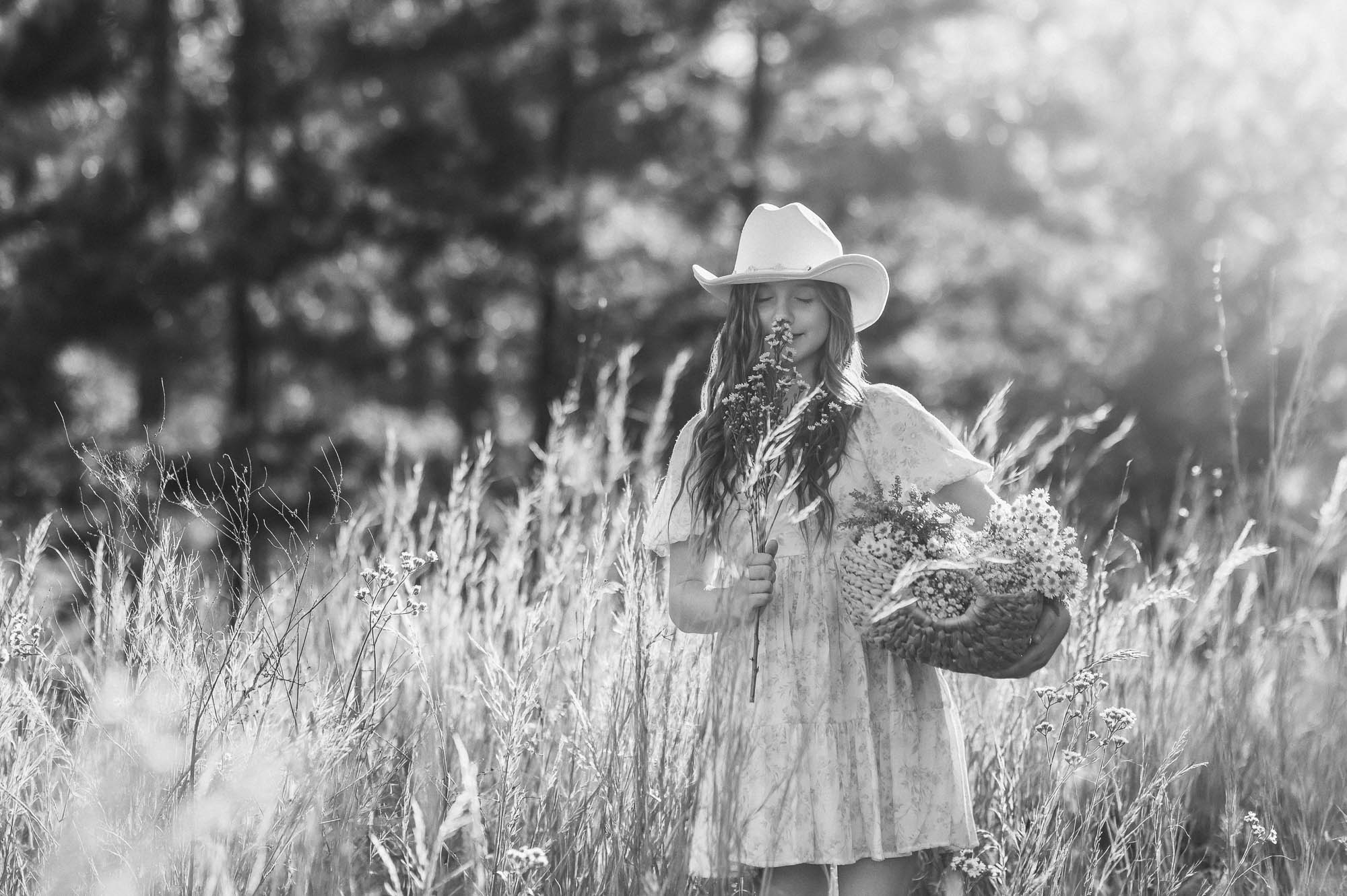 Child carrying a basket of flowers in a meadow | East Texas Child Photographer 