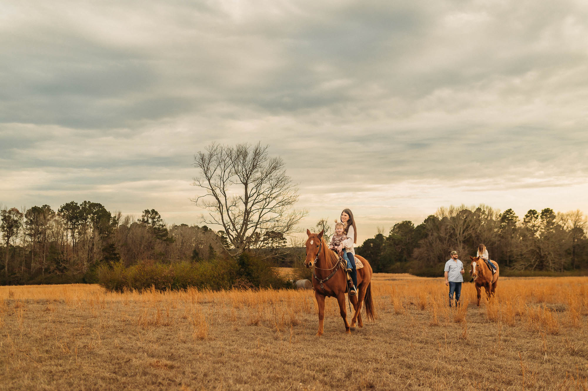 Family Riding Horses in an open meadow | East Texas Equestrian Family Photographer
