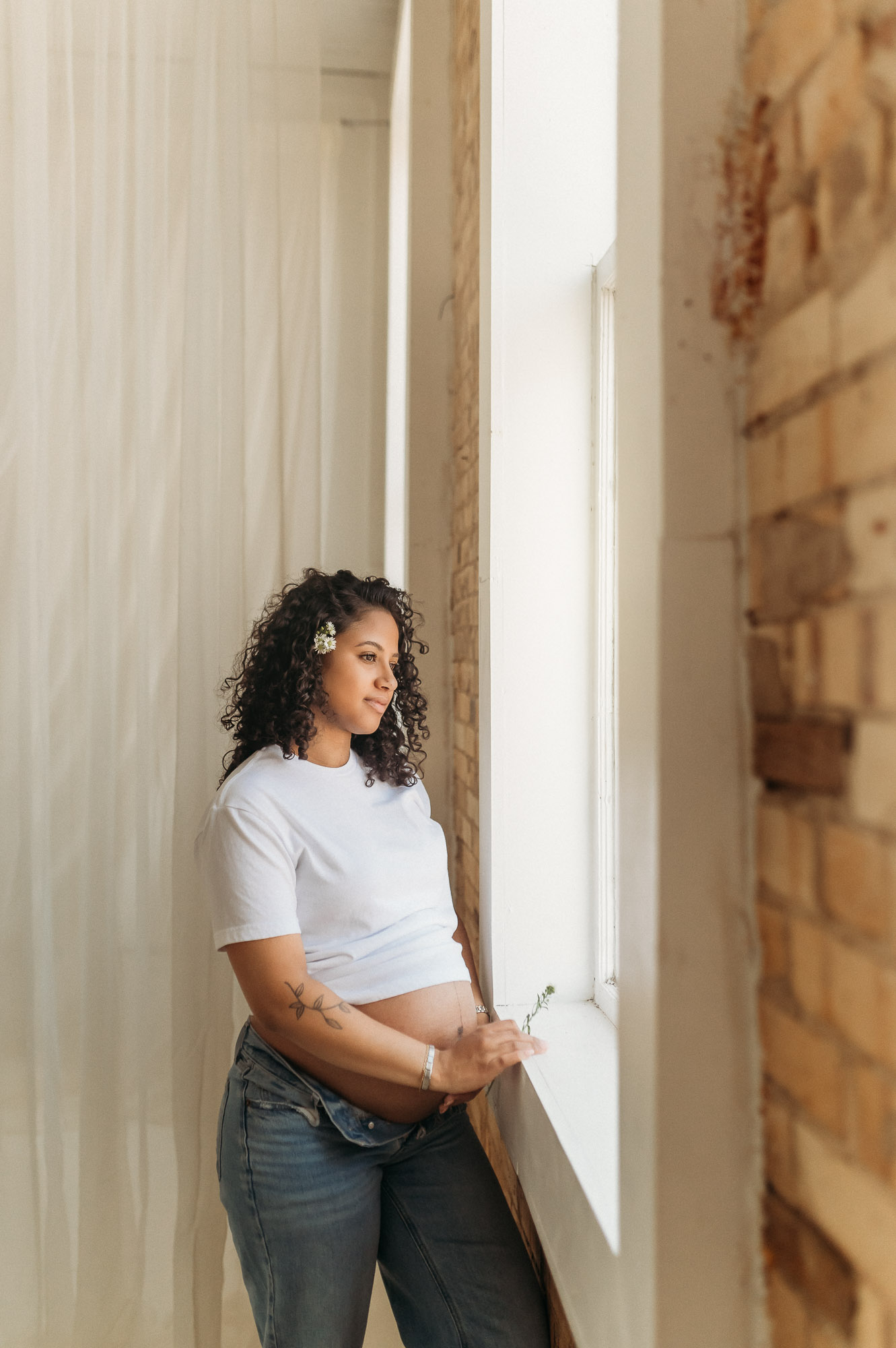 An expecting mom posing in front of a studio window | Lindale Texas Maternity Photographer 