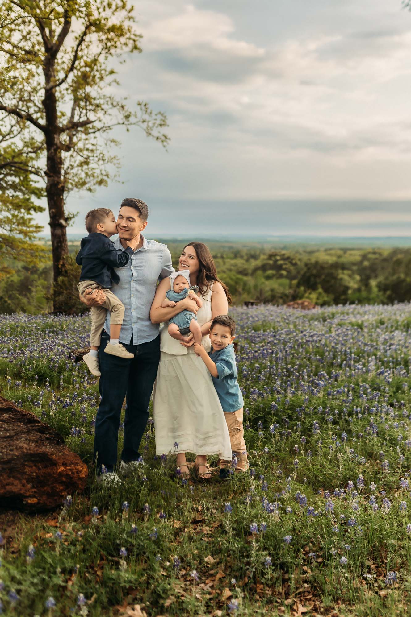 Family connecting with each other in a field of bluebonnets | ETX Bluebonnet Family Photos