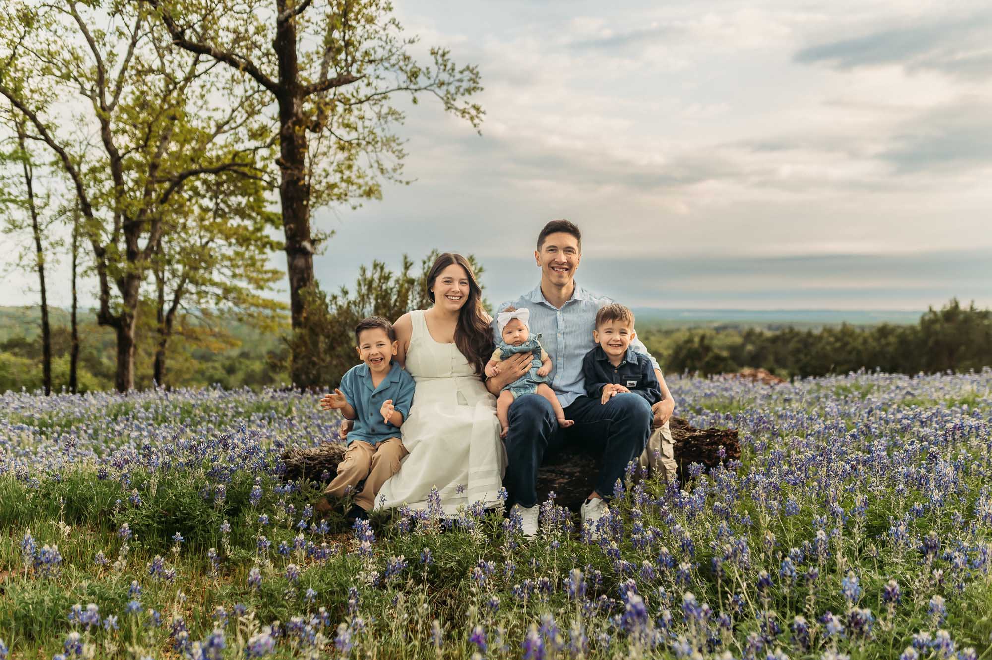 Family connecting with each other in a field of bluebonnets | ETX Bluebonnet Family Photos