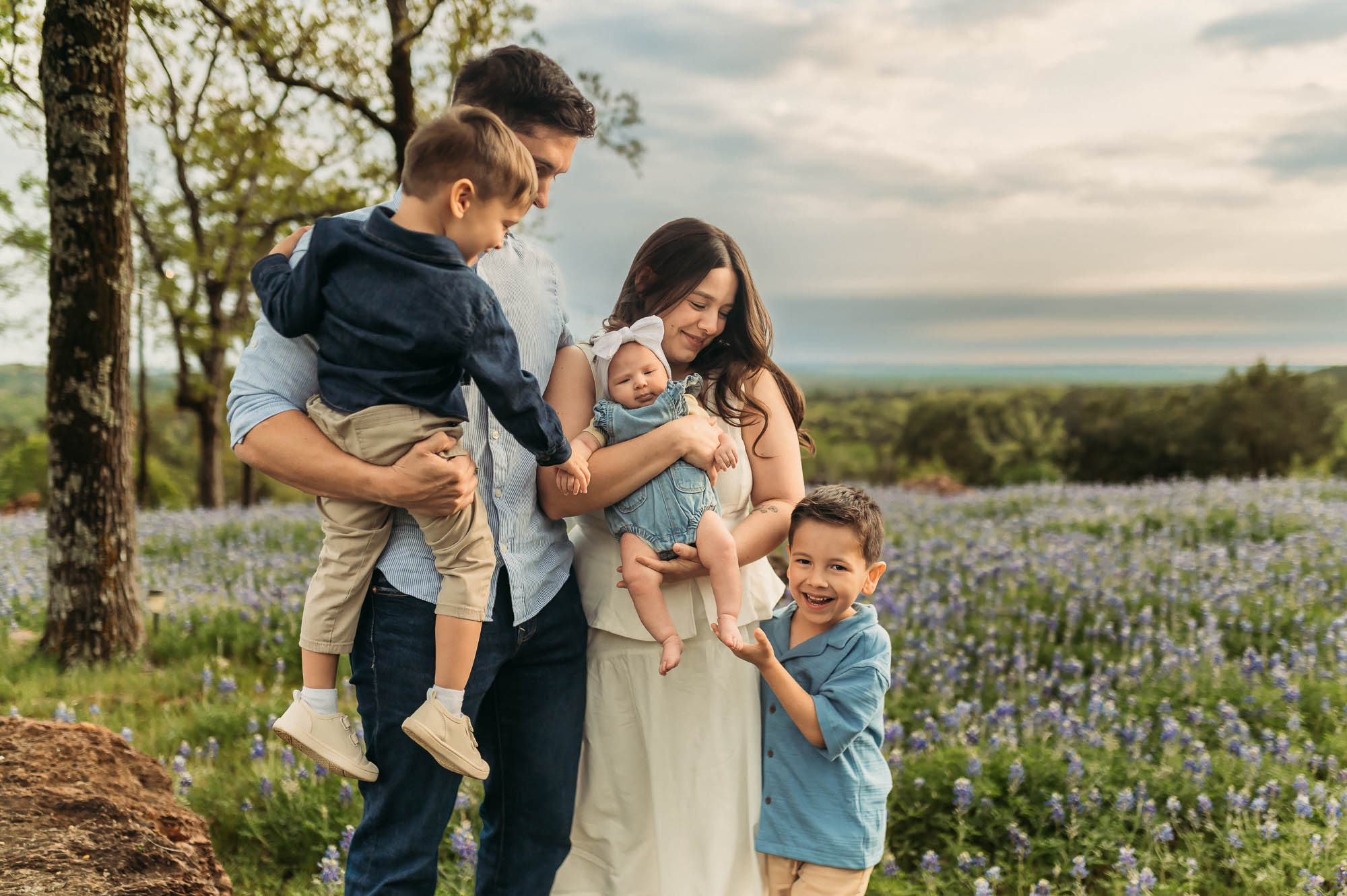 Family connecting with each other in a field of bluebonnets | ETX Bluebonnet Family Photos