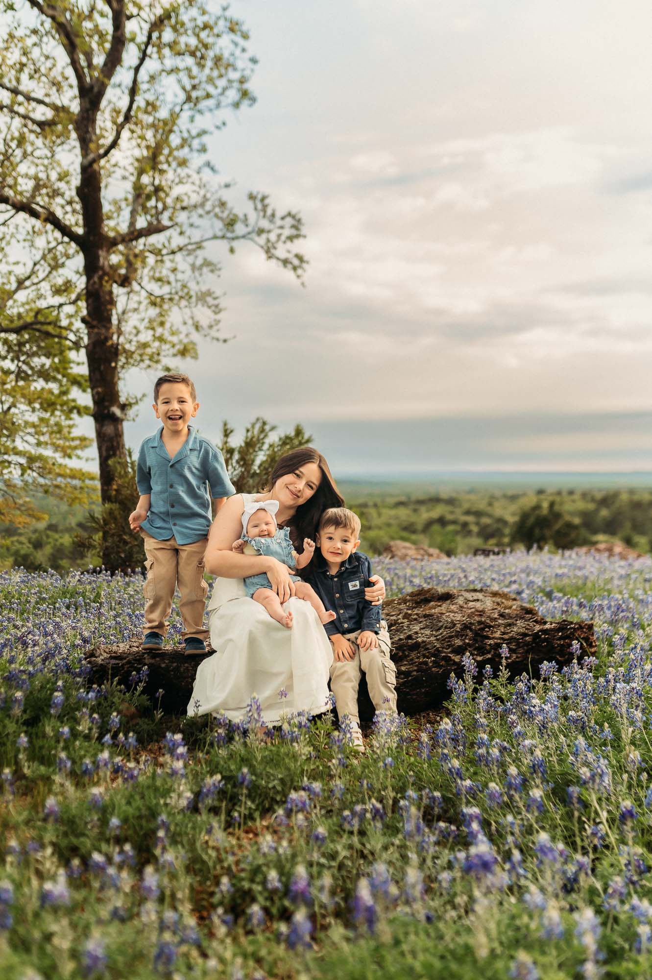 Family connecting with each other in a field of bluebonnets | ETX Bluebonnet Family Photos