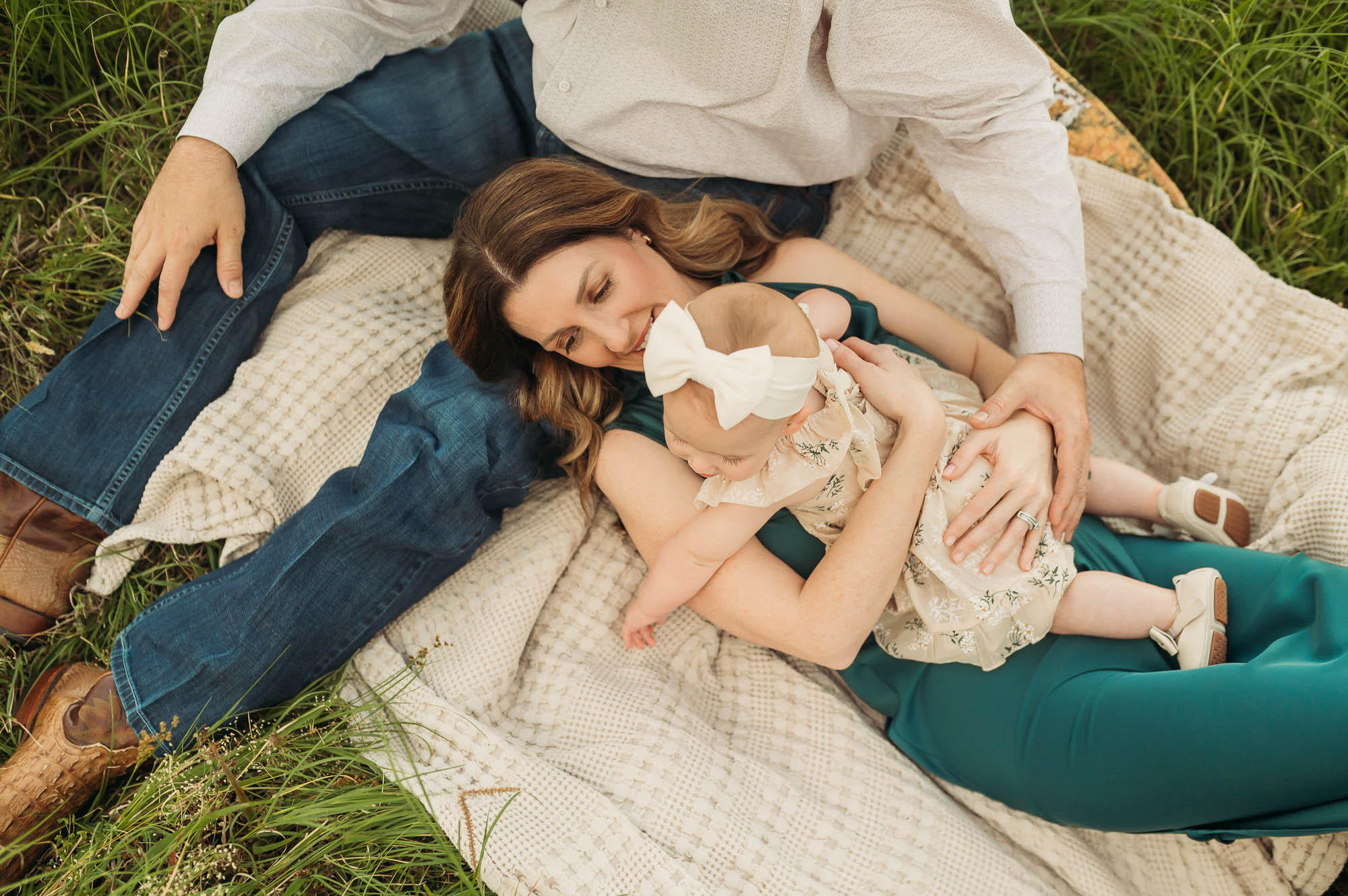 a family sitting in a meadow together | East Texas Lifestyle Photographer