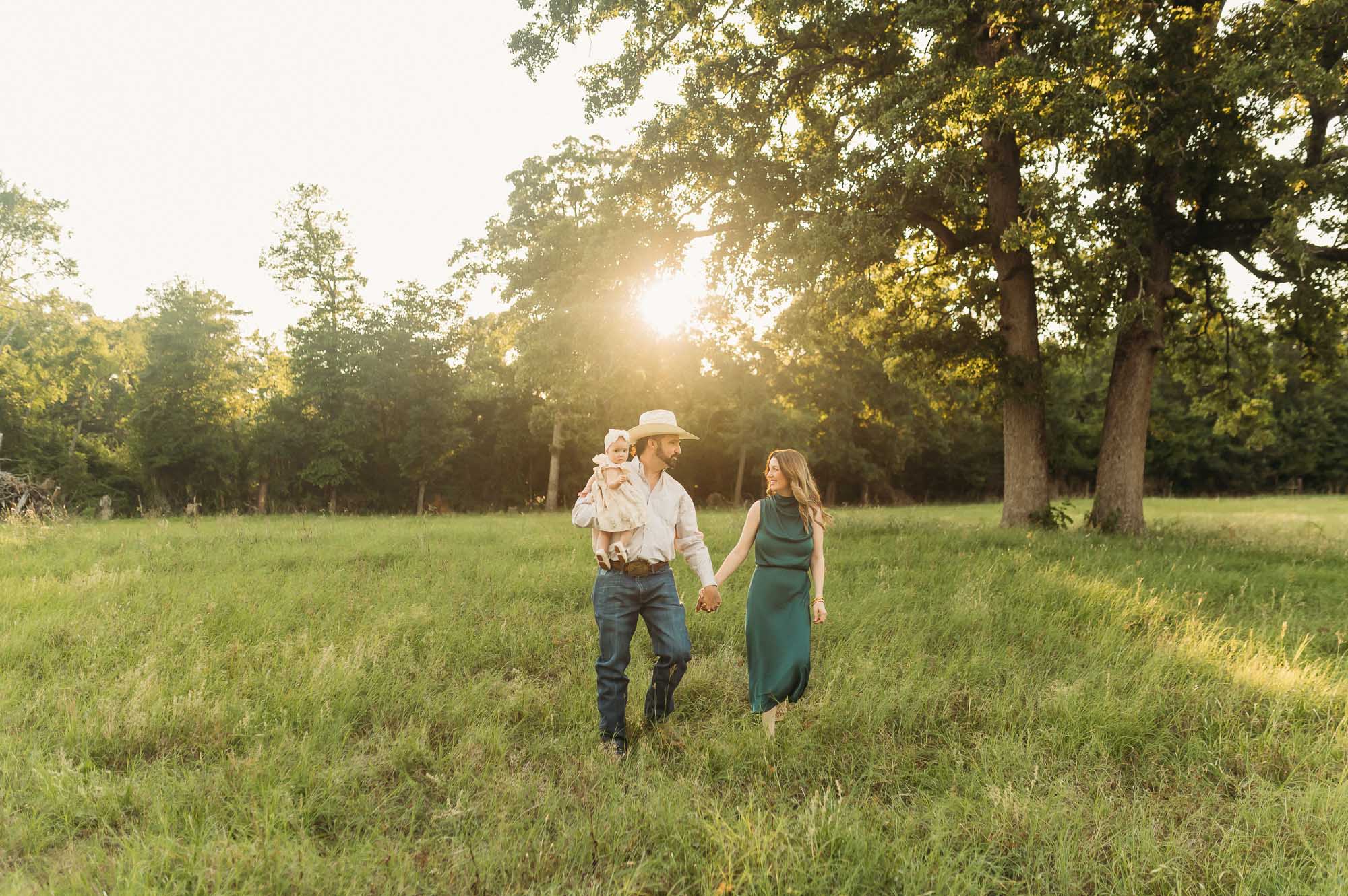 A family portrait walking together through a meadow | East Texas Lifestyle Photographer