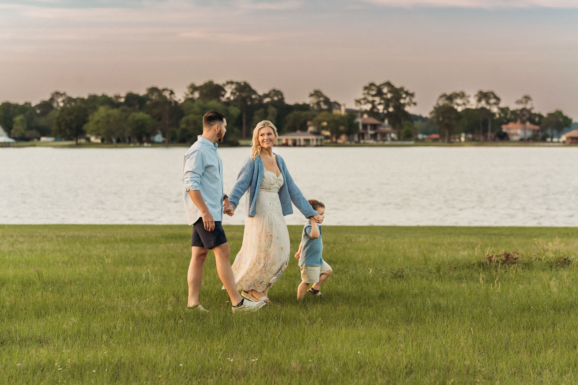 family walking in grass by a lake | Lake Tyler Family Photography