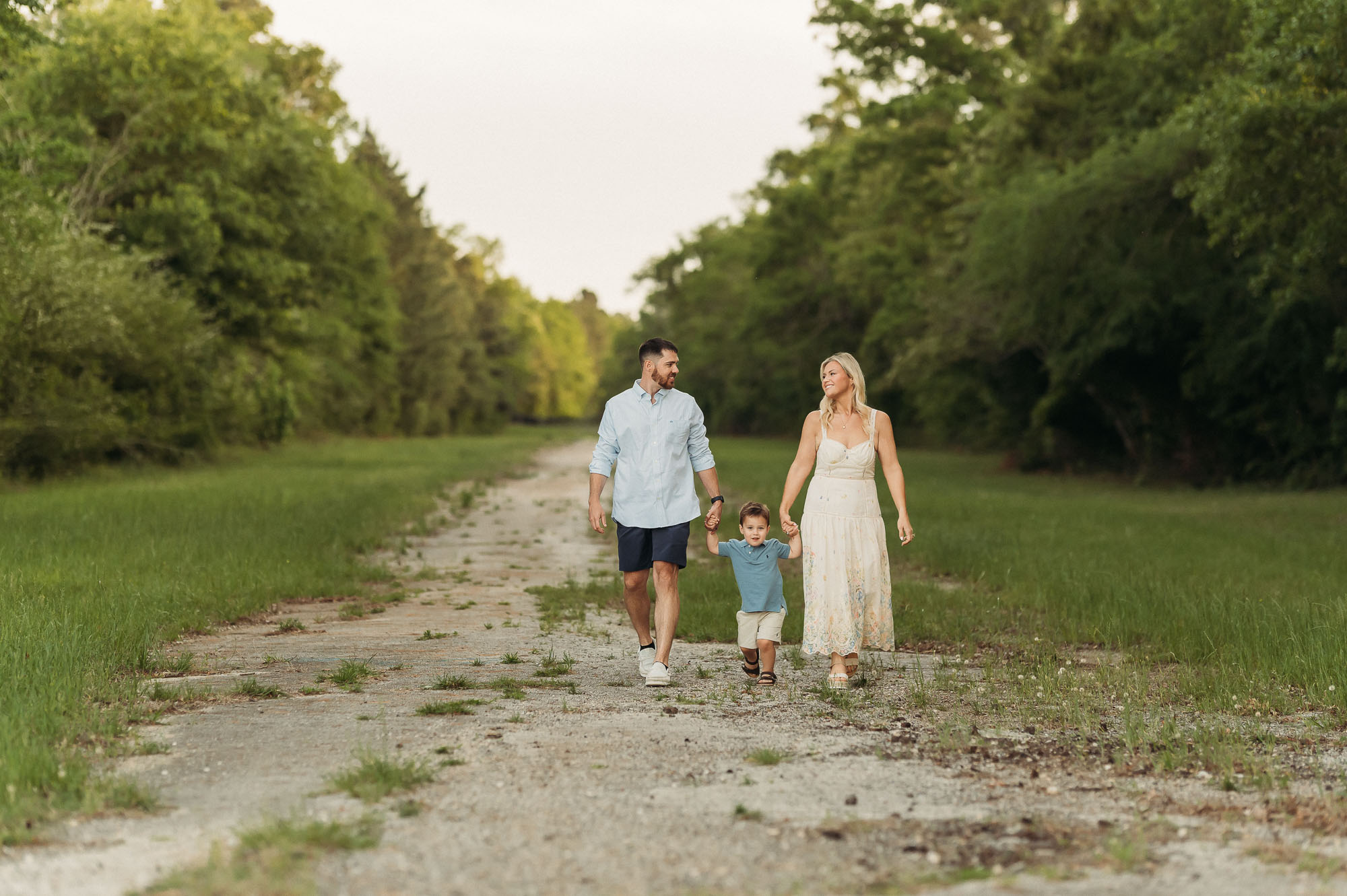 Family Walking Together down grassy path | Lake Tyler Family Photography