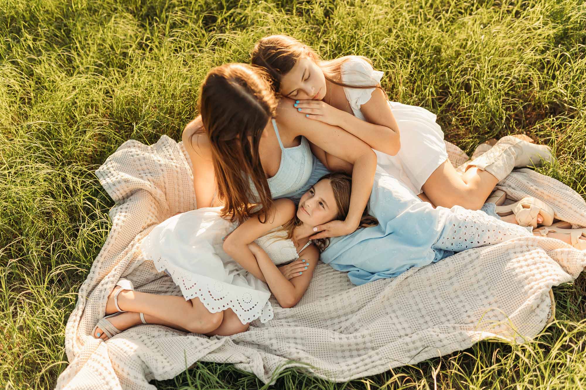 Mother and daughters hugging in a meadow | Motherhood Photography Tyler TX