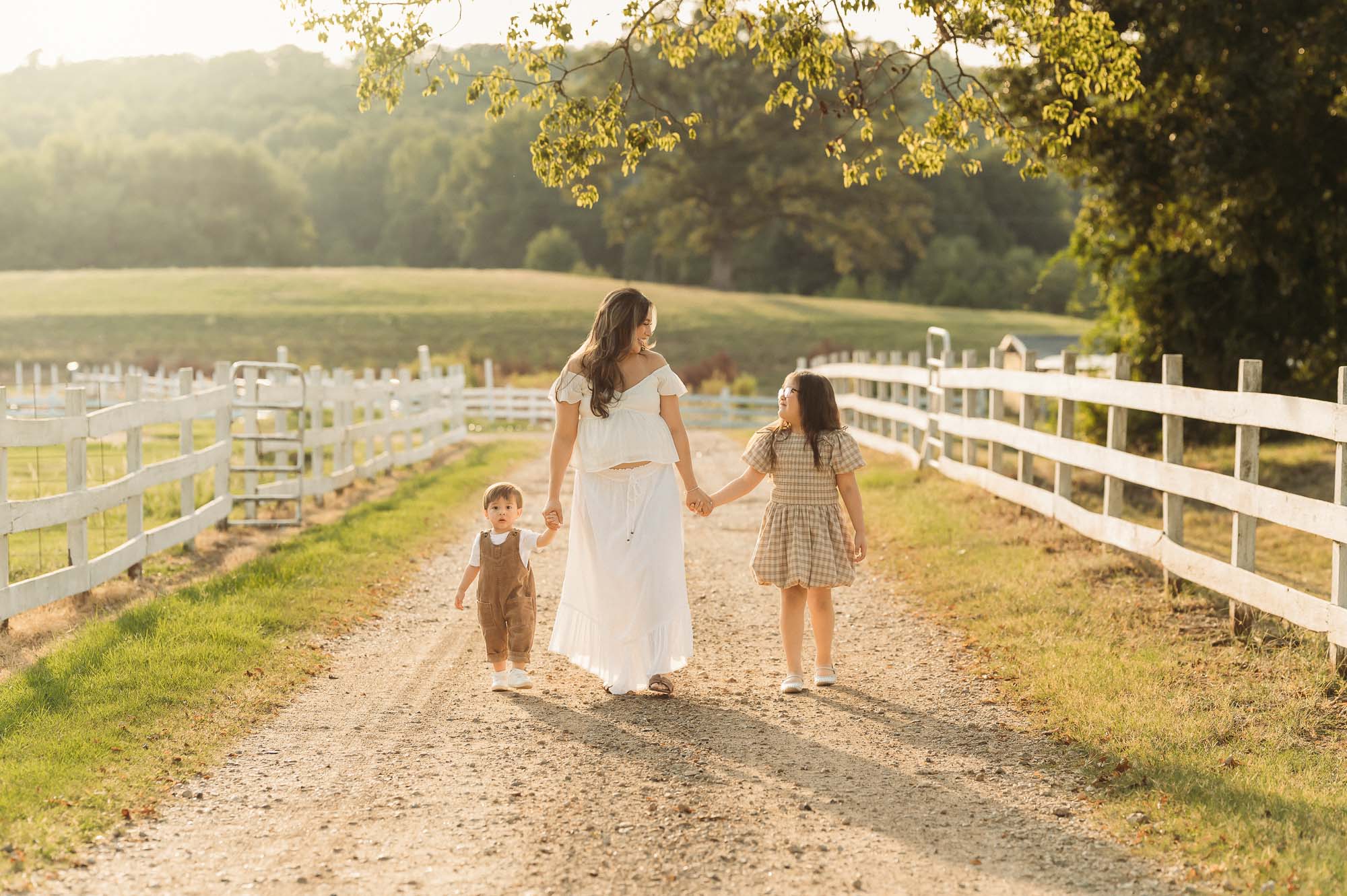 Mother and children enjoying a golden hour maternity session at Flying H Ranch