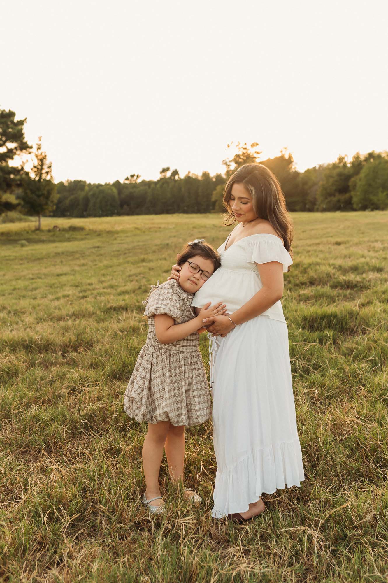 Mother and children enjoying a golden hour maternity session at Flying H Ranch