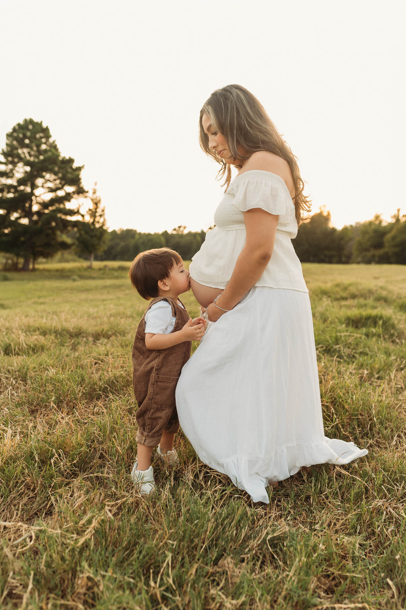 Mother and children enjoying a golden hour maternity session at Flying H Ranch