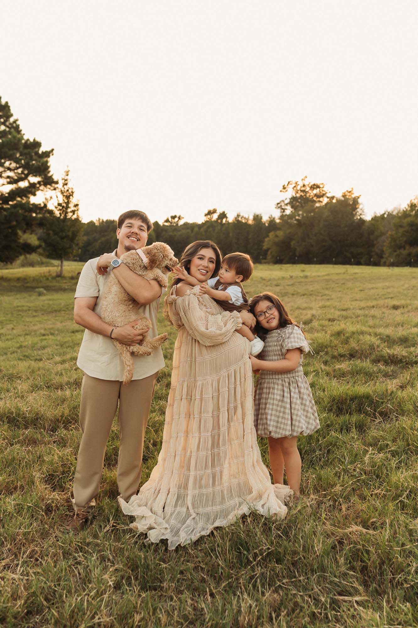 Family maternity portraits in a field at Flying H Ranch near Tyler Texas