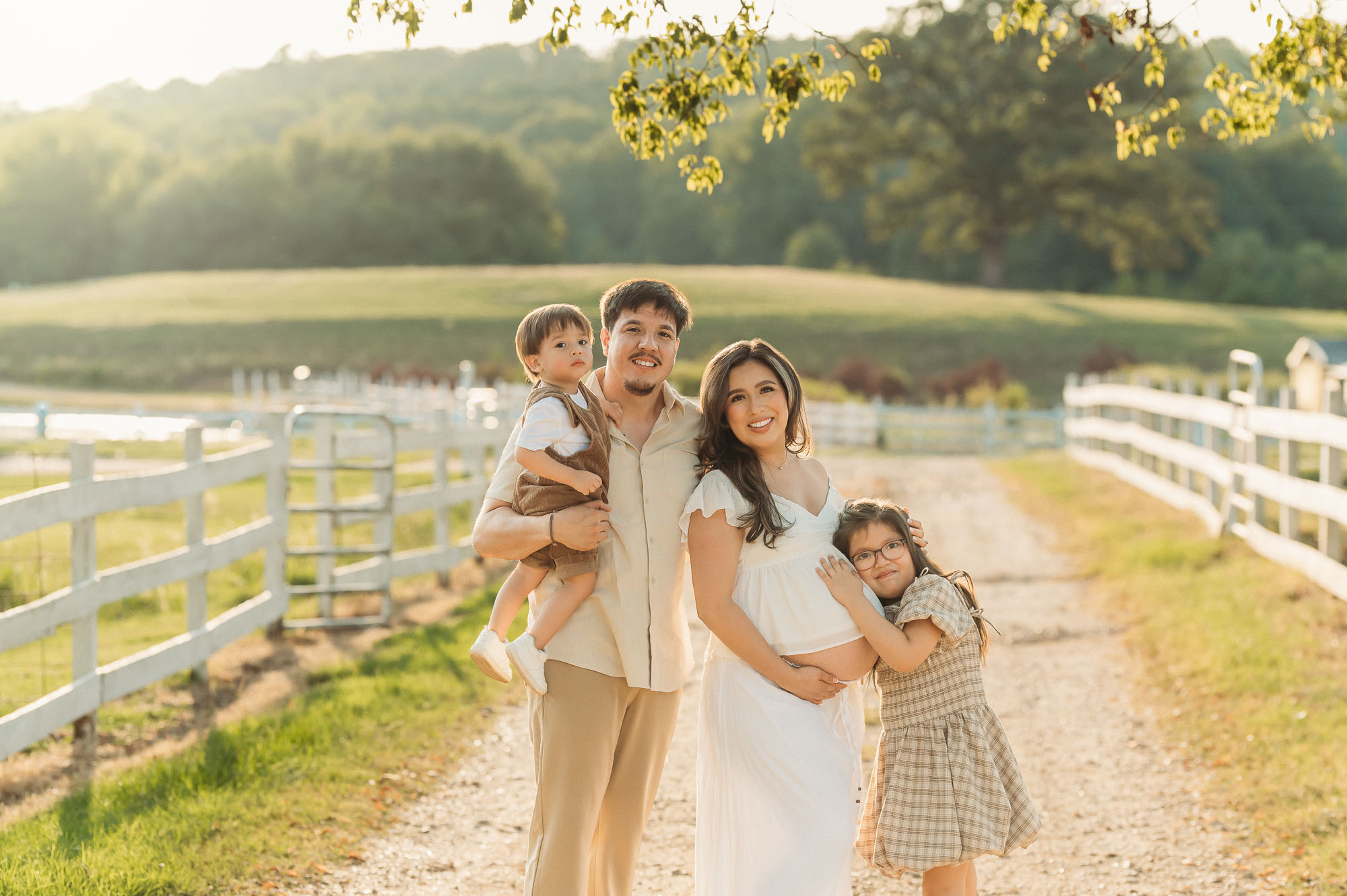 Family of four enjoying a maternity session at Flying H Ranch in Tyler Texas