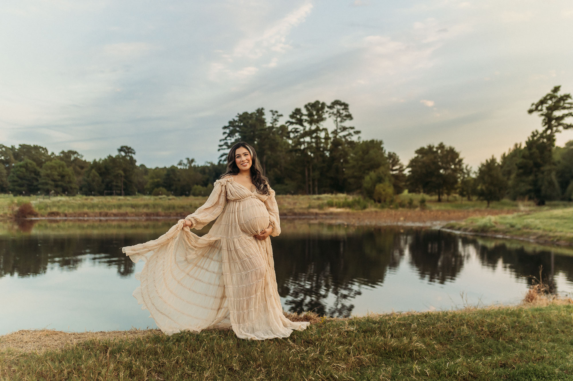 Expecting mother posing beside a pond during her Tyler Texas maternity session